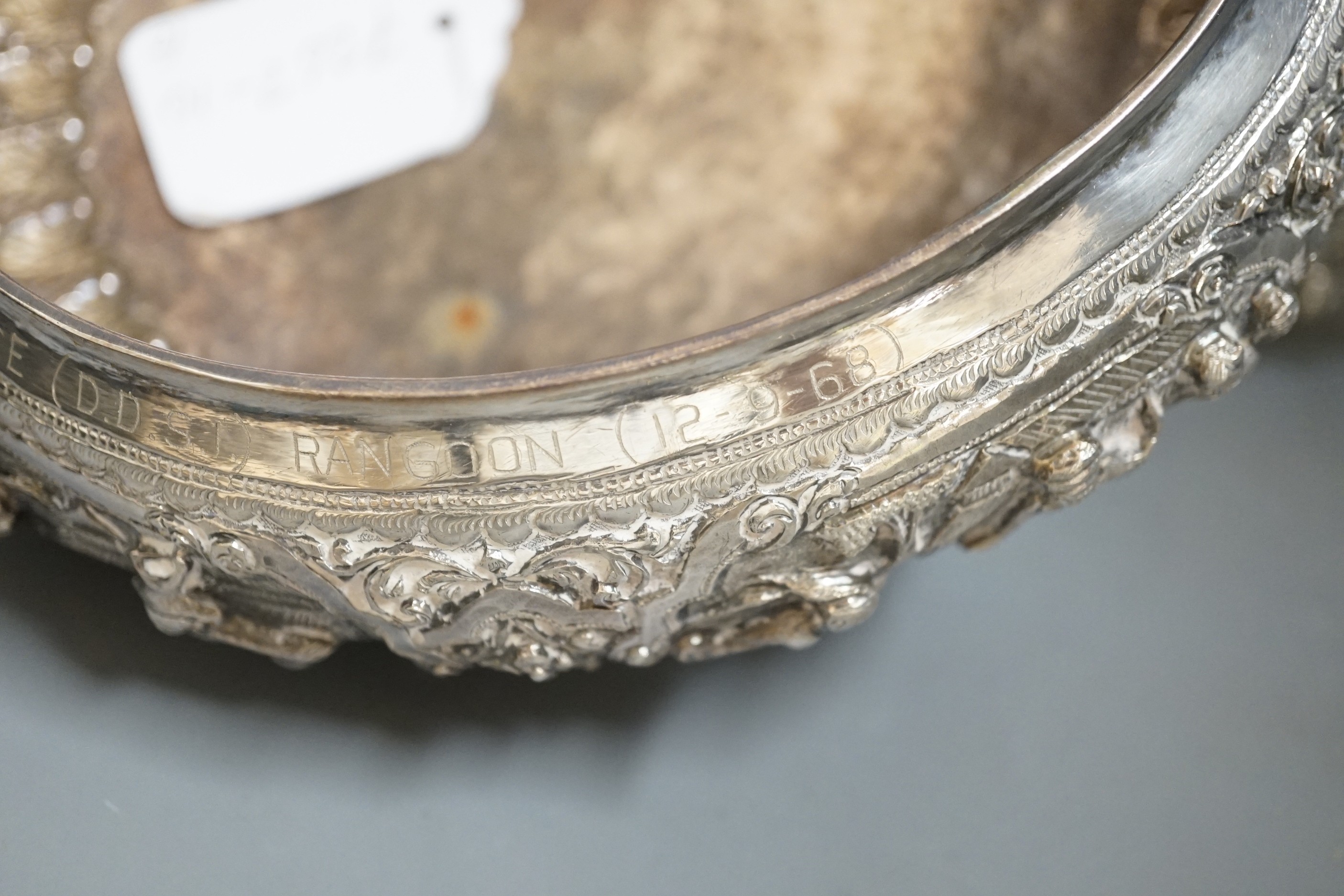 An Indian repousse white metal presentation bowl, with engraved inscription, diameter 21.5cm and a similar smaller bowl